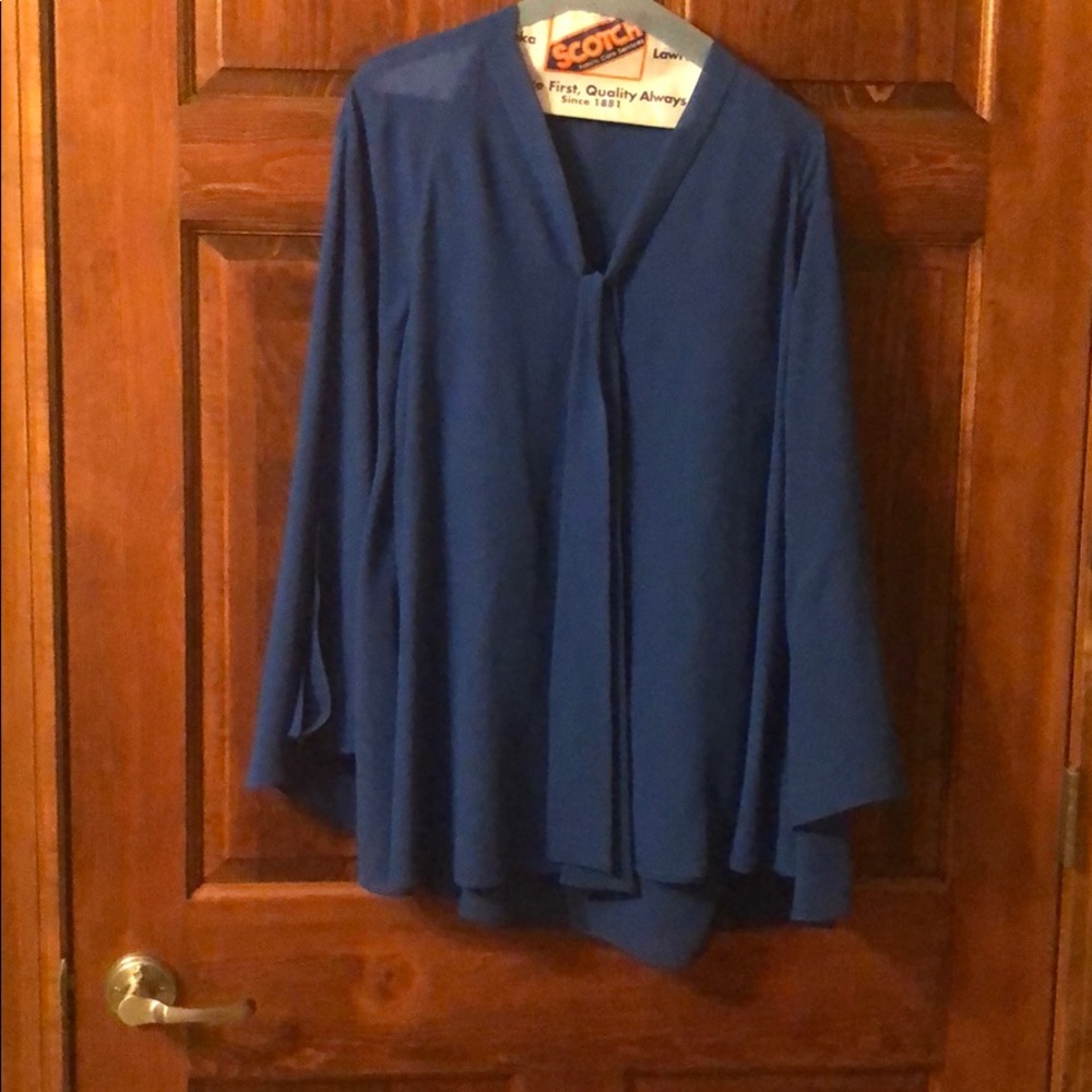 Open long sleeved blue button up blouse